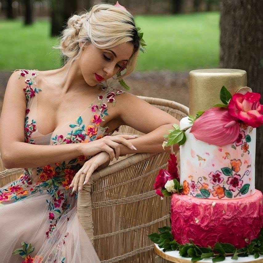 Woman posing with a decorated cake