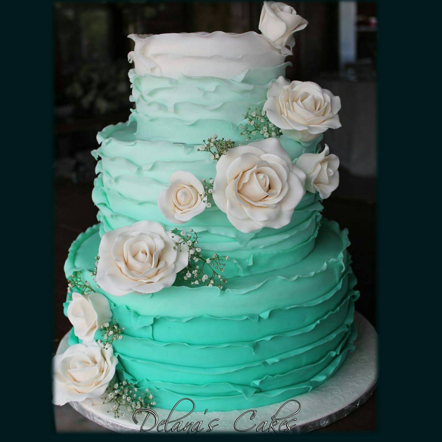 Turquoise tiered cake with roses